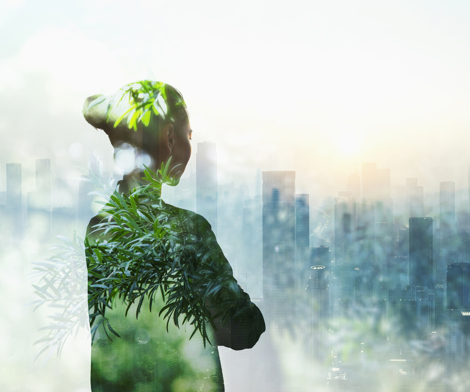 Person standing in contemplation in urban city with nature trees composite